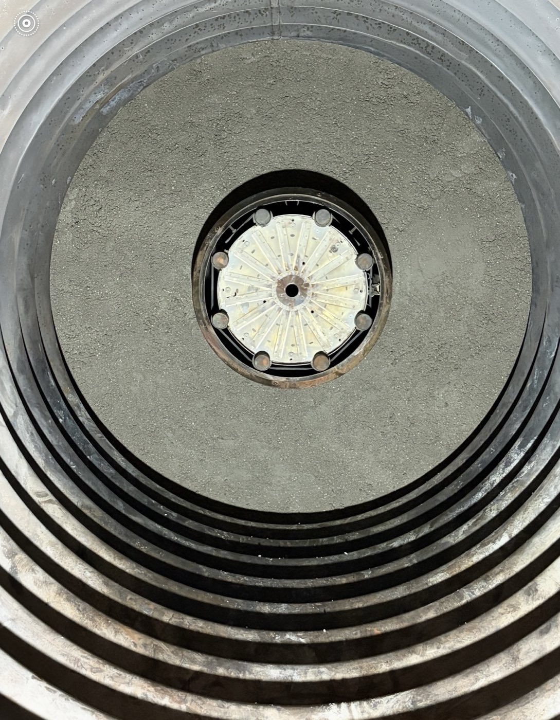 Refractory-lined circular boiler door with its central burner assembly.